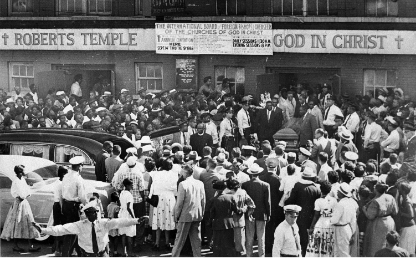 Black and white photo of a large crowd outside the church