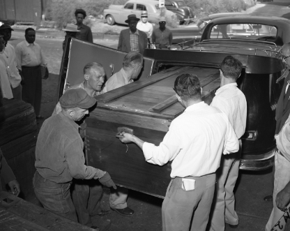 Black and white photo of Emmett Till's casket being unloaded